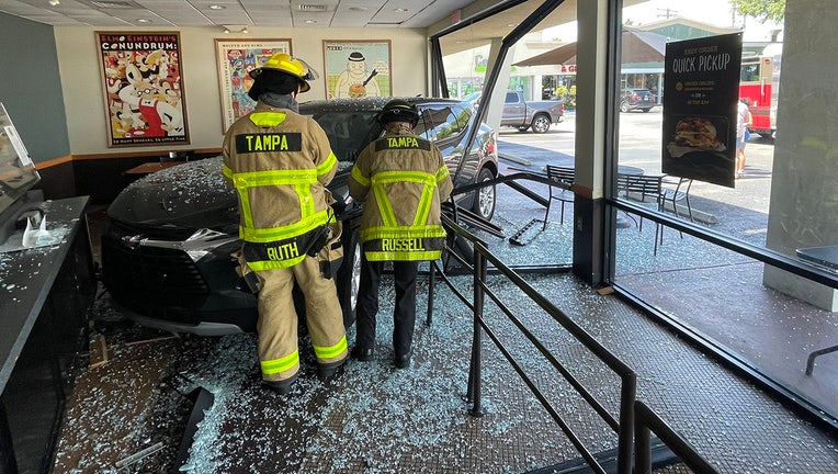 Photo: Black SUV crashed into front window of Tampa Einstein Bros. bagel store, ending up completely inside the restaurant.