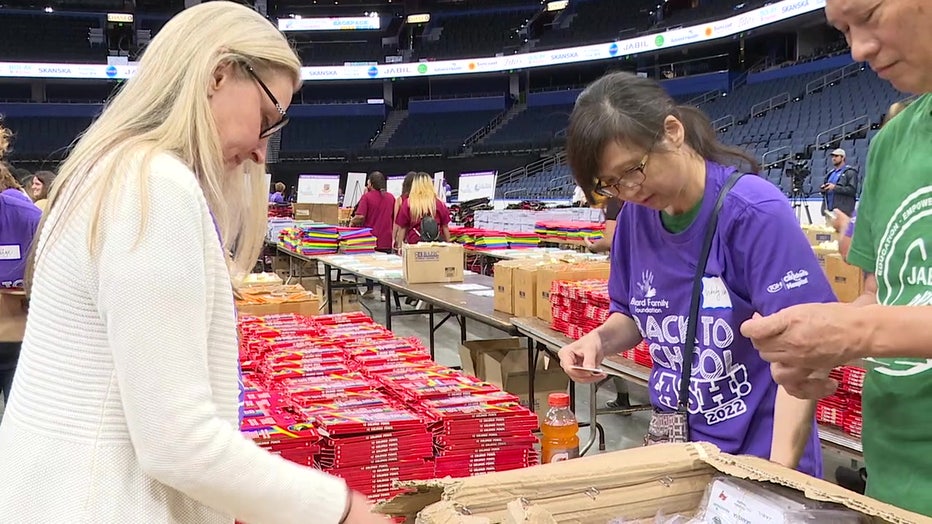 Volunteers build backpacks at Amalie Arnea.