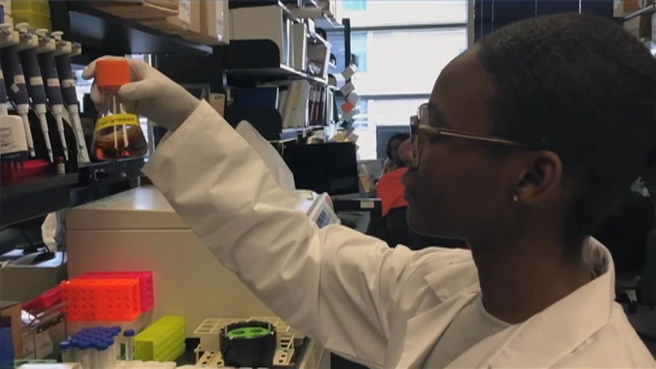 Woman in lab with mixing solutions.