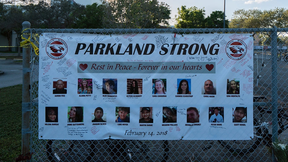 Photo: Sign outside Marjory Stoneman Douglas High that reads "Parkland Strong" and shows images of each victim.