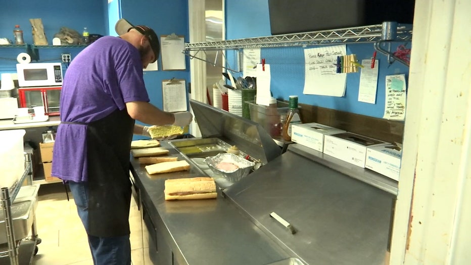 Photo: Carroll's Corner Market employee making sandwiches
