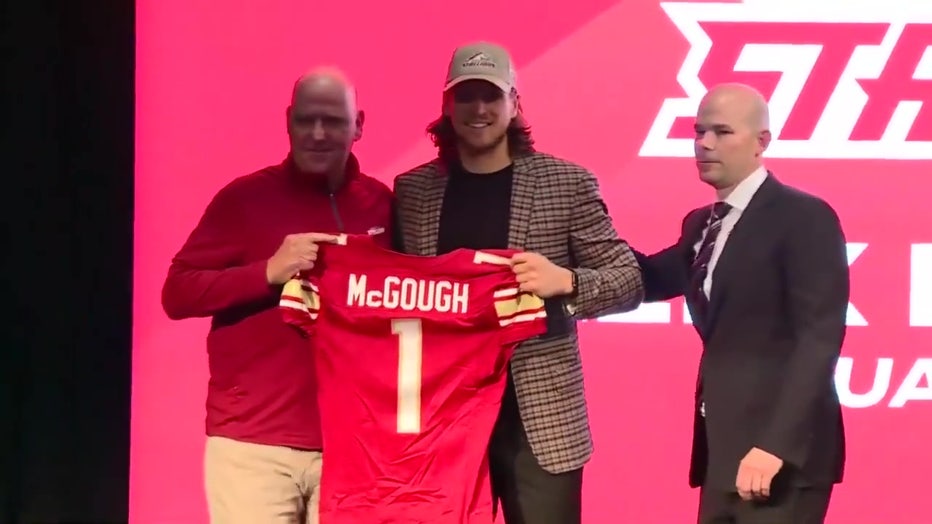 Alex McGough holding jersey.