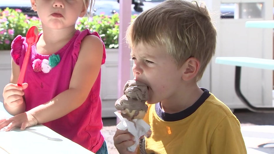 Child eating chocolate ice cream.