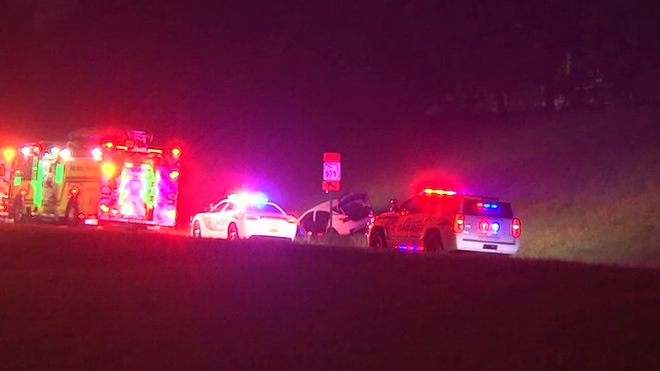 Police lights and cars on I-75 following fatal shooting. 