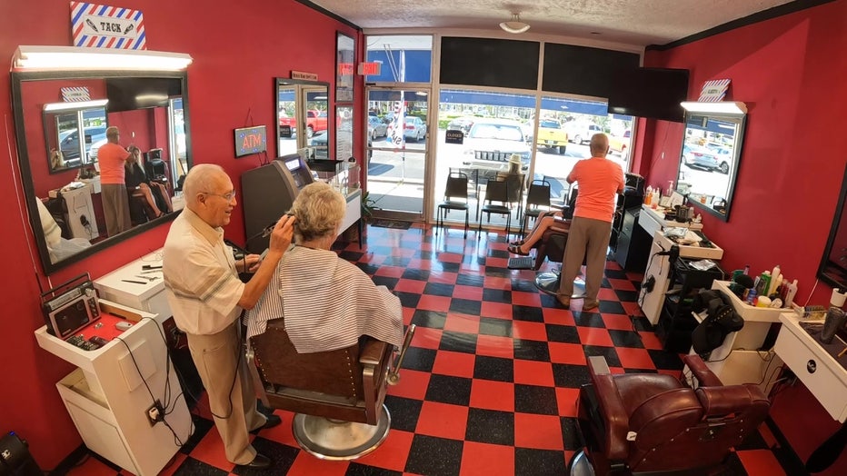 91-year-old barber cuts hair at barber shop on Treasure Island.