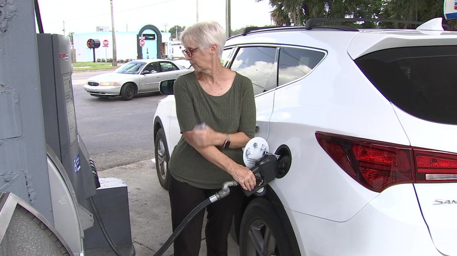 Woman pumping gas