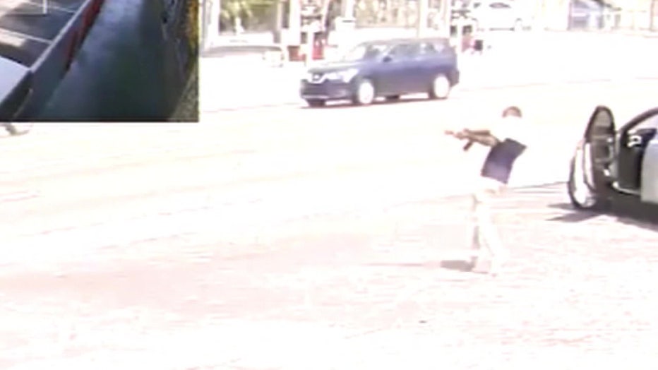 Surveillance image of Mingo with rifle outside Tampa pawn shop.