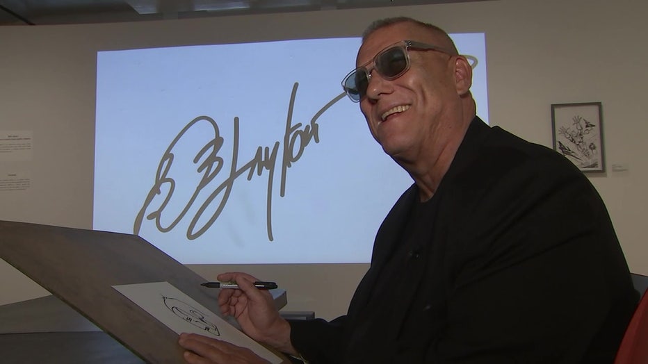 Bob Layton with autograph behind him