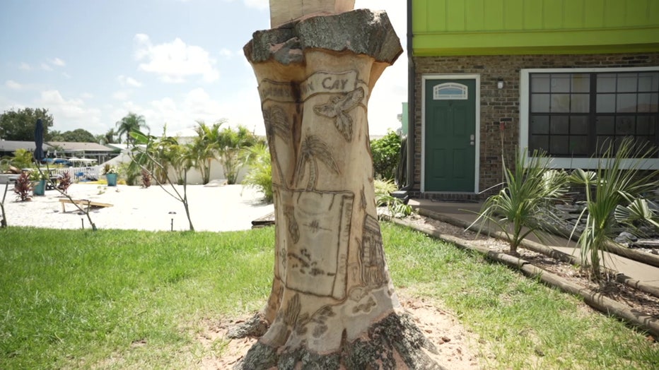 Tree with sea scene carved into it. 