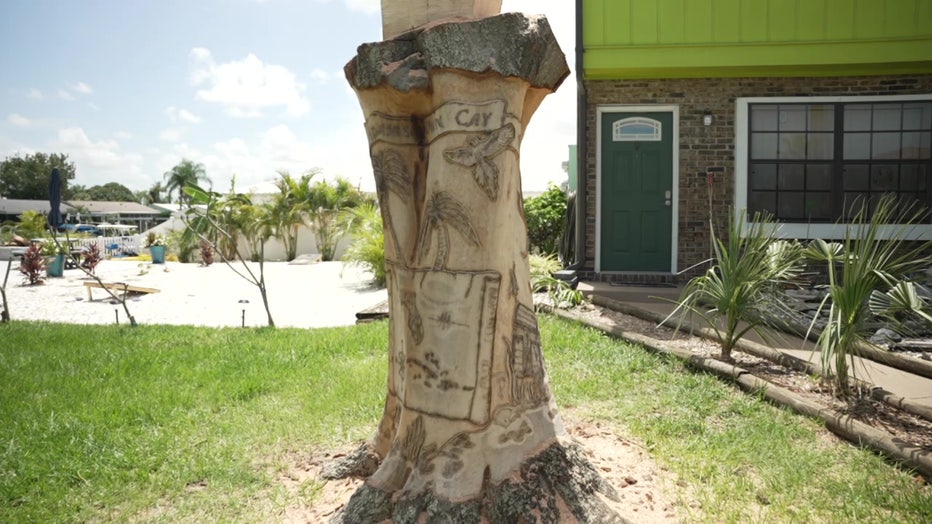 Tree with sea scene carved into it.