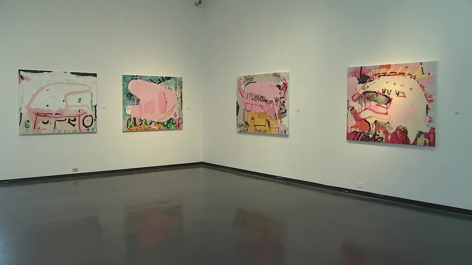 Paintings on the wall in Dark Matter exhibit