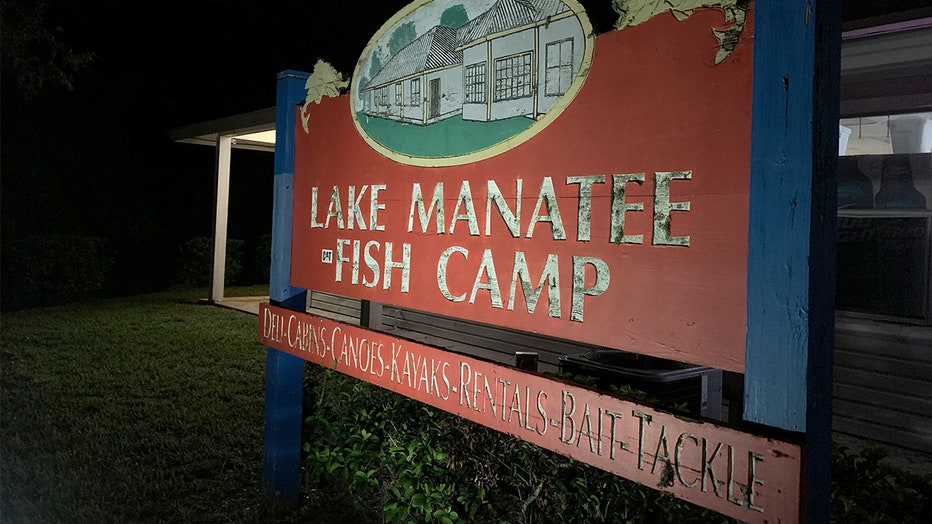 Photo: Red and blue sign that reads Lake Manatee Fish Camp