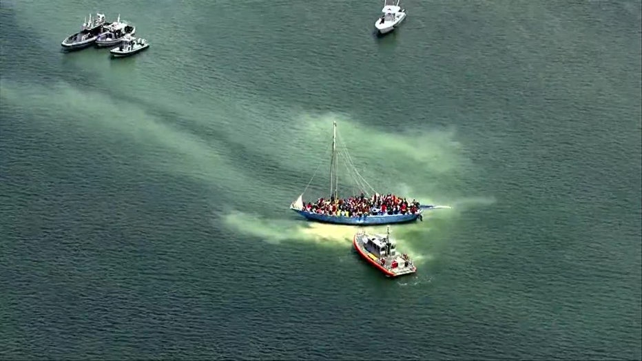 Photo: Large number of migrants sit aboard a grounded sailboat off the coast of South Florida.