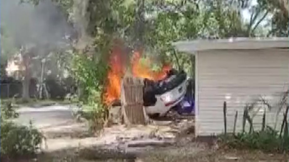 Photo shows the burning Lamborghini moments after it landed on the roof of a Fort Lauderdale home, then fell to the ground.