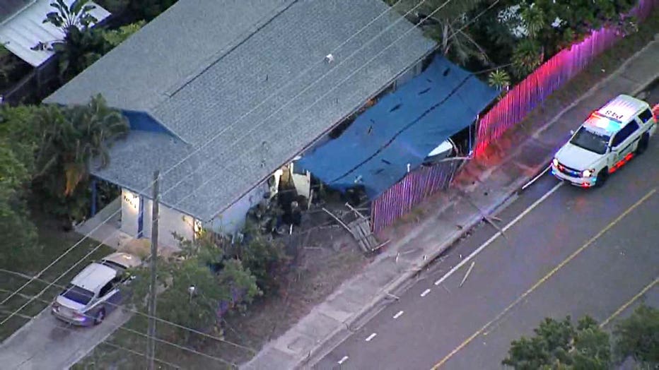 Photo: Aerial view showing a shattered fence and debris around the Pinellas Park home