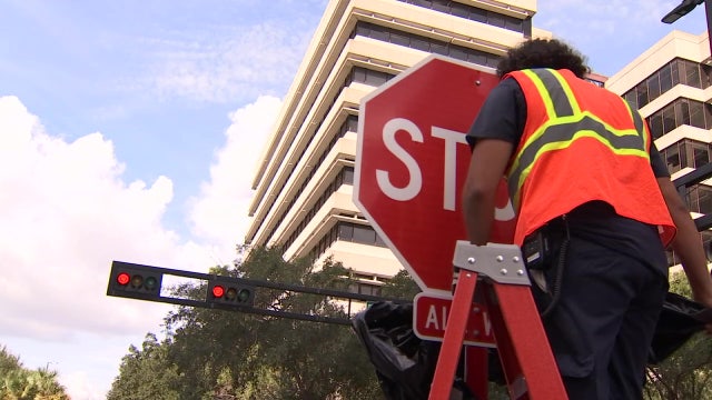Stop signs replace street lights in busy pedestrian area of downtown Tampa