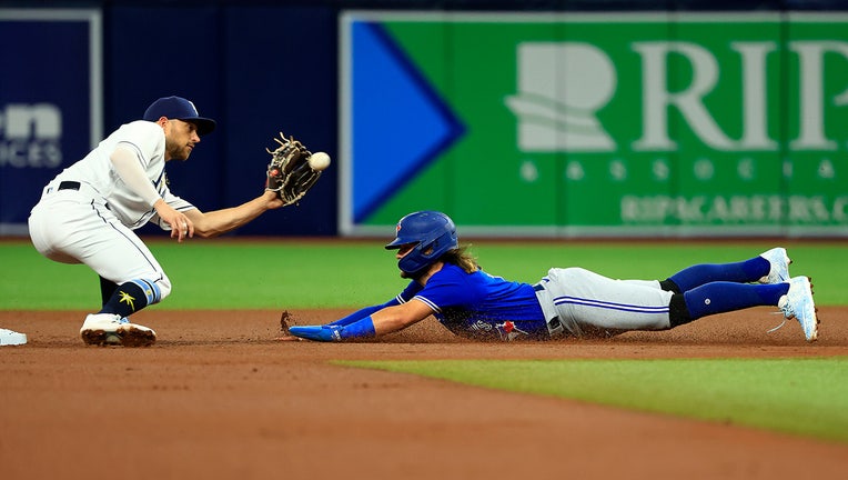 Photo: Bo Bichette of the Toronto Blue Jays is seen stealing second by Brandon Lowe of the Tampa Bay Rays.