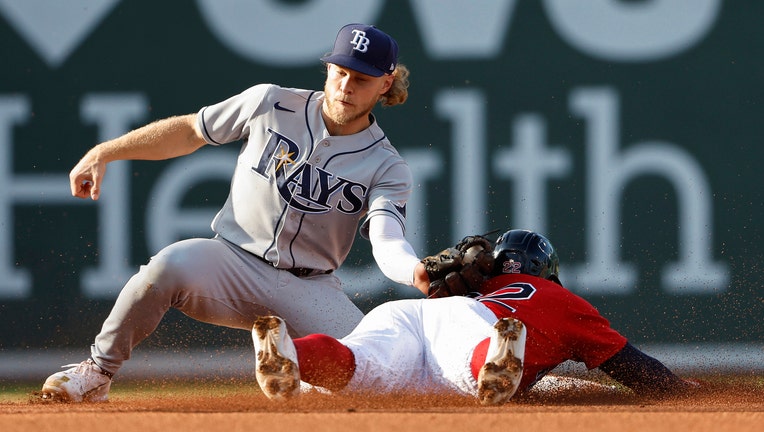 aylor Walls #0 of the Tampa Bay Rays tags out Tommy Pham #22 of the Boston Red Sox trying to steal second base during the fourth inning at Fenway Park on August 27, 2022 in Boston, Massachusetts. 