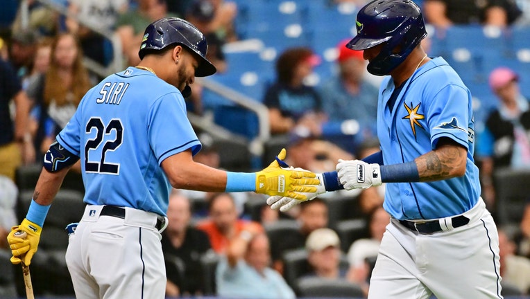 Christian Bethancourt #14 of the Tampa Bay Rays celebrates with Jose Siri #22 after hitting a home run in the second inning against the Kansas City Royals at Tropicana Field on August 21, 2022 in St Petersburg, Florida. 