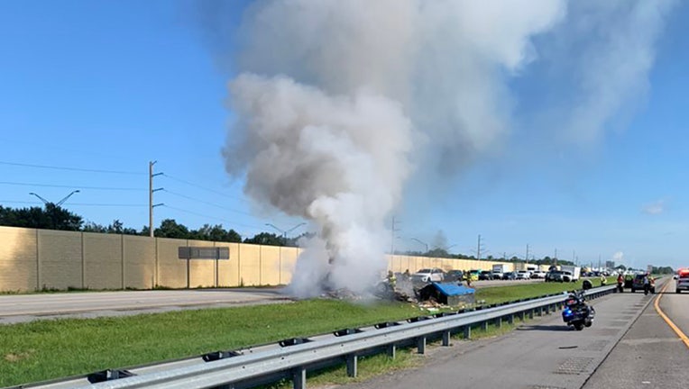 Photo: A food truck's tire blew, causing the vehicle to flip and catch fire on I-75.