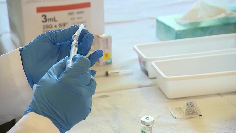 Photo: A medical professional prepares doses of the polio vaccine.