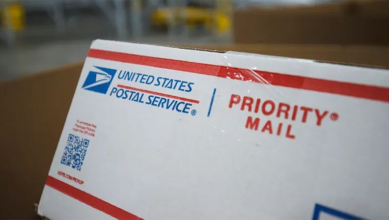 Photo: Close-up view of the USPS logo on a piece of priority mail packaging.