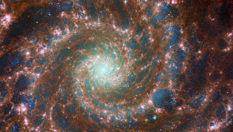 Photo: M74 shines at its brightest in this combined optical/mid-infrared image, featuring data from both the NASA/ESA Hubble Space Telescope and the NASA/ESA/CSA James Webb Space Telescope.