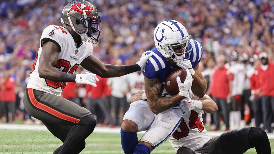 Michael Pittman Jr. #11 of Indianapolis Colts is tackled by Nolan Turner #34 of Tampa Bay Buccaneers during the first half of a preseason game at Lucas Oil Stadium on August 27, 2022 in Indianapolis, Indiana.