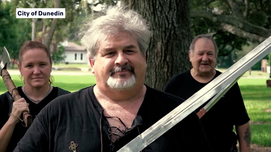 Photo: Men in kilts, holding swords for Dunedin PSA on cleaning up after your pets.