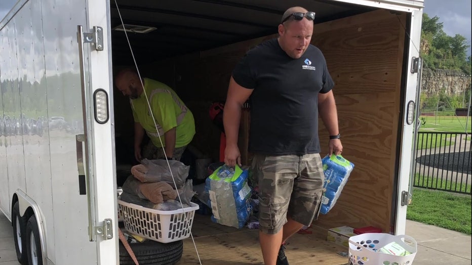 Man with OneMission Disaster Response carrying water