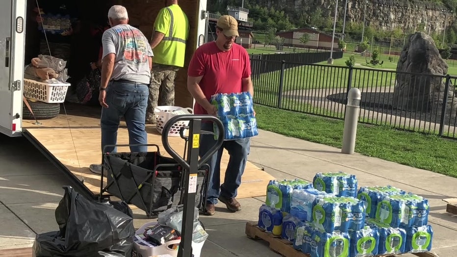Volunteers with OneMission Disaster Response carrying water.