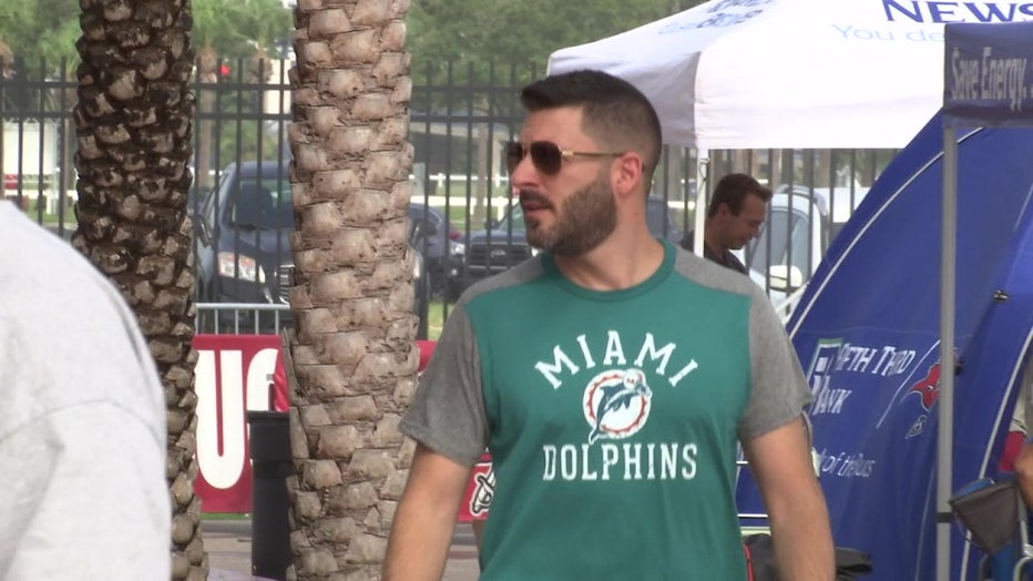A Dolphins fan attends Buccaneers practice ahead of Saturday's game.