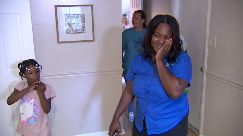 Chiquerria Jones is excited to look at her home after it was furnished by the Pineapple Projects.