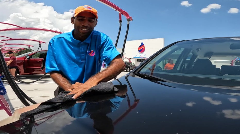 Man hand washes a car at one of the many car washes across the Bay Area.