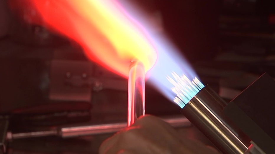 Cech bends, twists and rolls the heated glass while in the heat envelope of her specialized torch.
