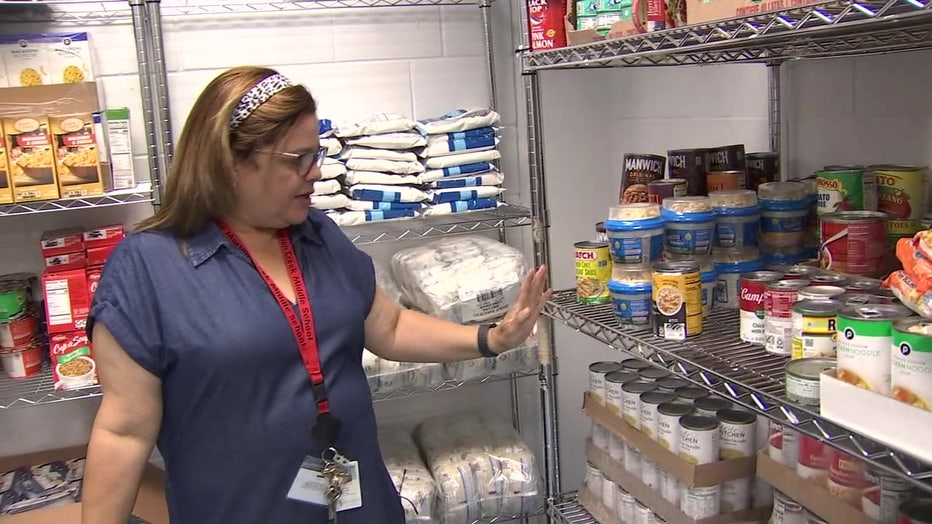 A woman stands inside the first food pantry located at a Polk County school. 