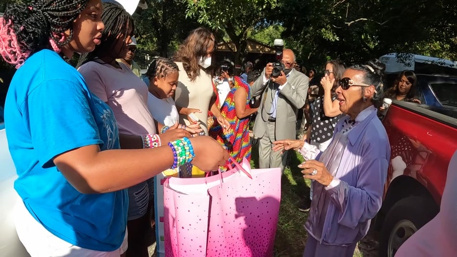 Dr. Xernona Clayton gives a select family presents to celebrate her 92nd birthday.