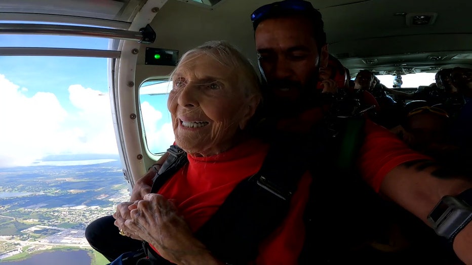 Rose Marie Bond gets ready to jump from the plane with an instructor.