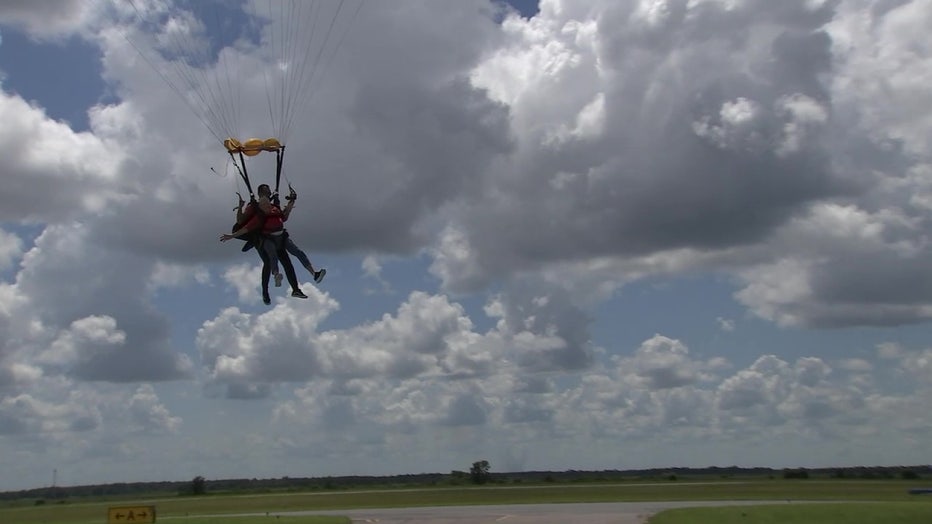 Rose Marie Bond and instructor get set to land after skydiving in Lake Wales.