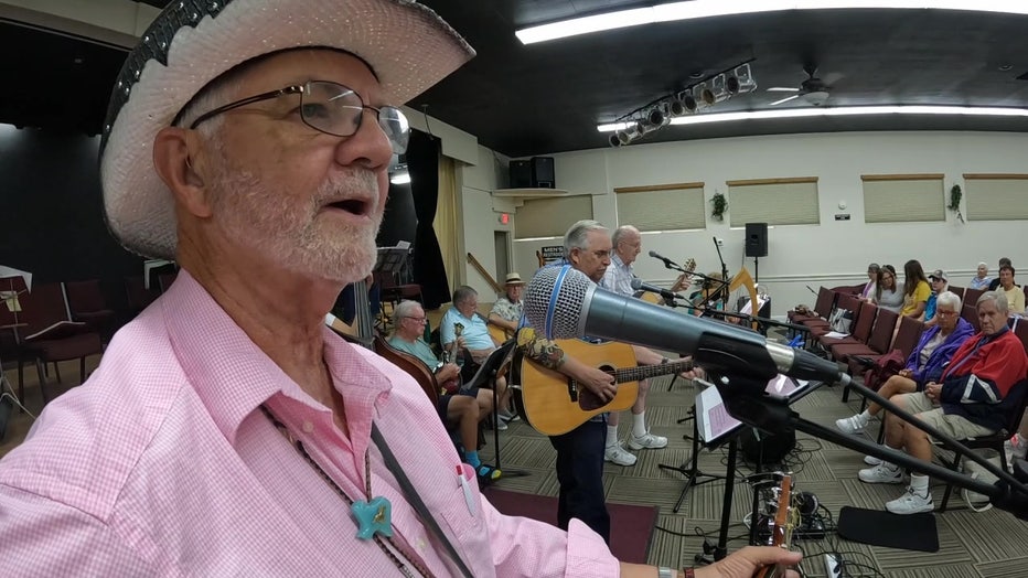 Front Porch Pickers playing on stage in Sun City Center.