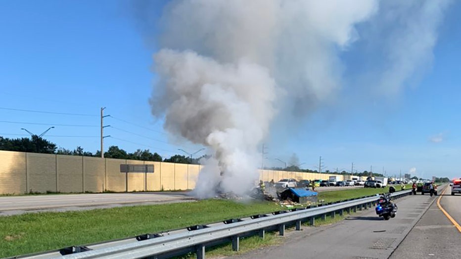 Photo: A food truck's tire blew, causing the vehicle to flip and catch fire on I-75.