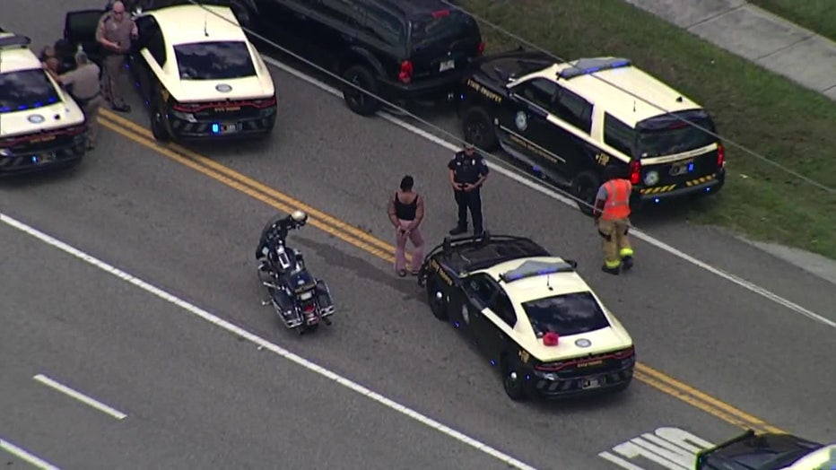 Photo: Aerial image from SkyFOX shows the suspect, identified by FHP as 32-year-old Grecham Toliver, in handcuffs after the crash.
