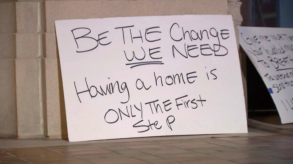 Photo: Sign sitting outside St. Pete City Hall says, 'Be the Change we need. Having a home is only the first step.'