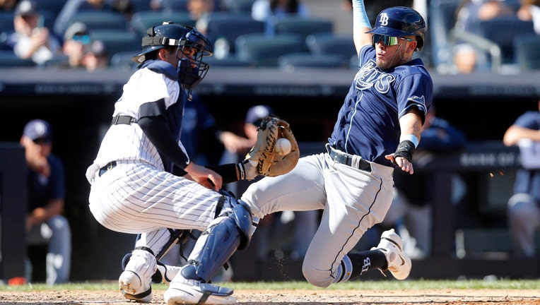  Pinch hitter Jonathan Aranda #62 of the Tampa Bay Rays beats the tag from Kyle Higashioka #66 of the New York Yankees for a run in the eighth inning at Yankee Stadium on September 10, 2022 in the Bronx borough of New York City.