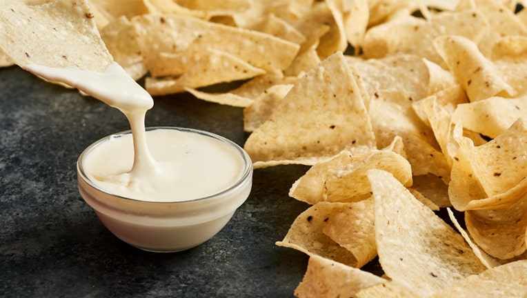 Photo: Chip dipped into small bowl of queso at Moe's Southwest Grill.