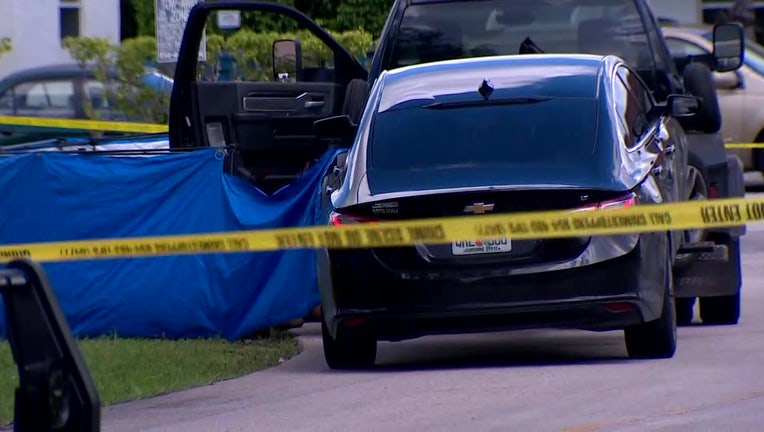 Photo: Police tape surrounds the crime scene where a police say a tow truck driver shot and killed a man during a confrontation over a car repossession in a South Florida neighborhood.
