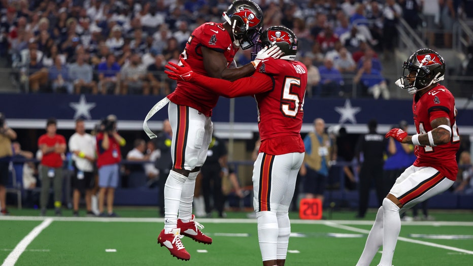 Devin White #45 of the Tampa Bay Buccaneers and Lavonte David #54 celebrate during the second half against the Dallas Cowboys at AT&amp;T Stadium on September 11, 2022
