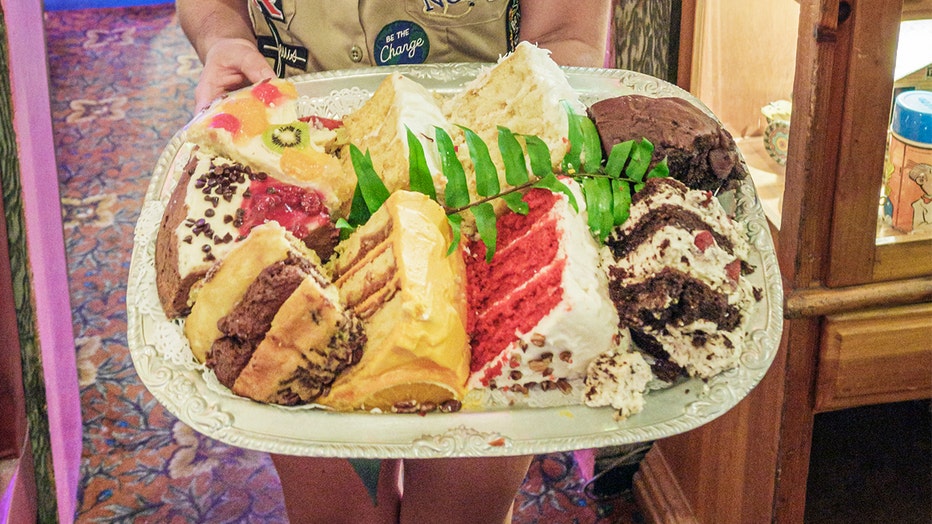 Photo: Server holds dessert tray inside Bubble Room. 