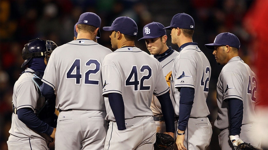 Photo: The Tampa Bay Rays gather on the pitchers mound in the fourth inning against the Boston Red Sox on April 16, 2010 at Fenway Park in Boston, Massachusetts. The Tampa Bay Rays wore the number 42 to honor Jackie Robinson. 