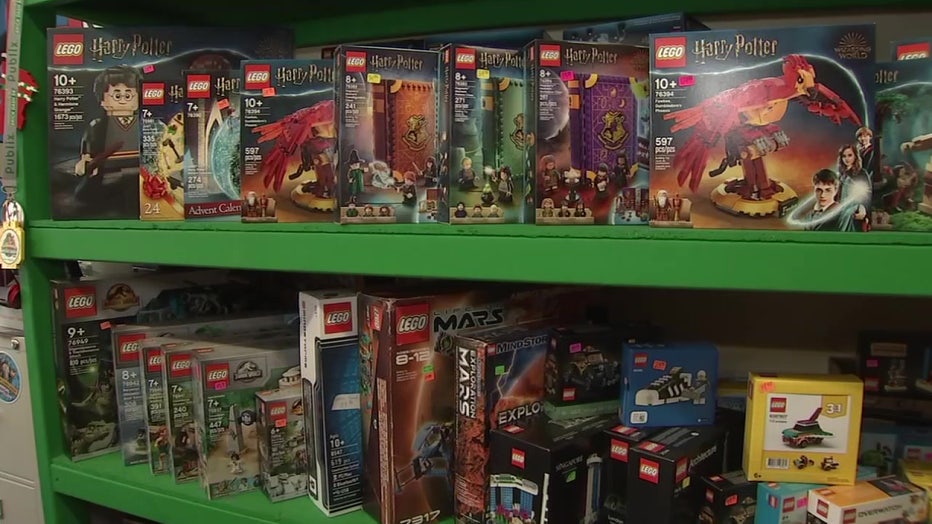 Boxes of Lego sets on the shelves. 